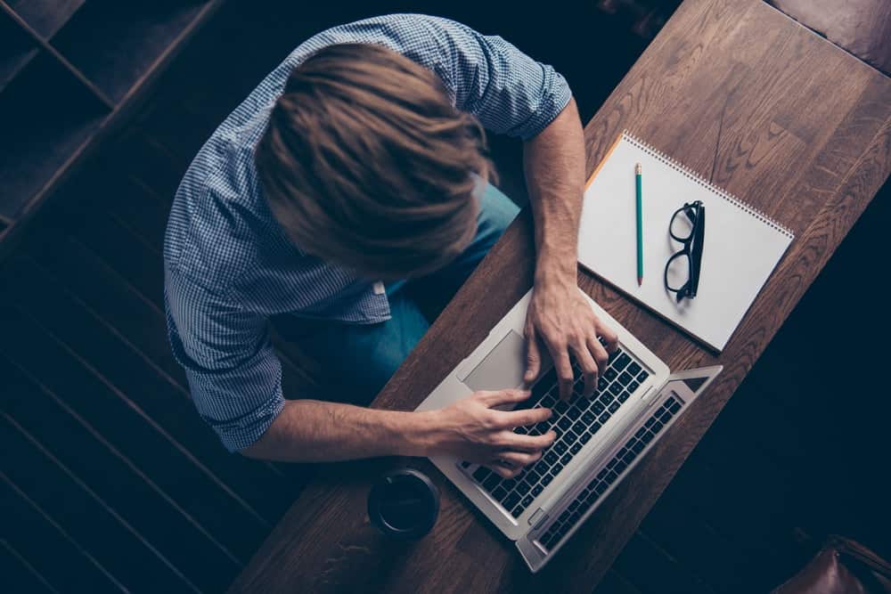 A freelance writer is working on his articles in a coffeeshop.