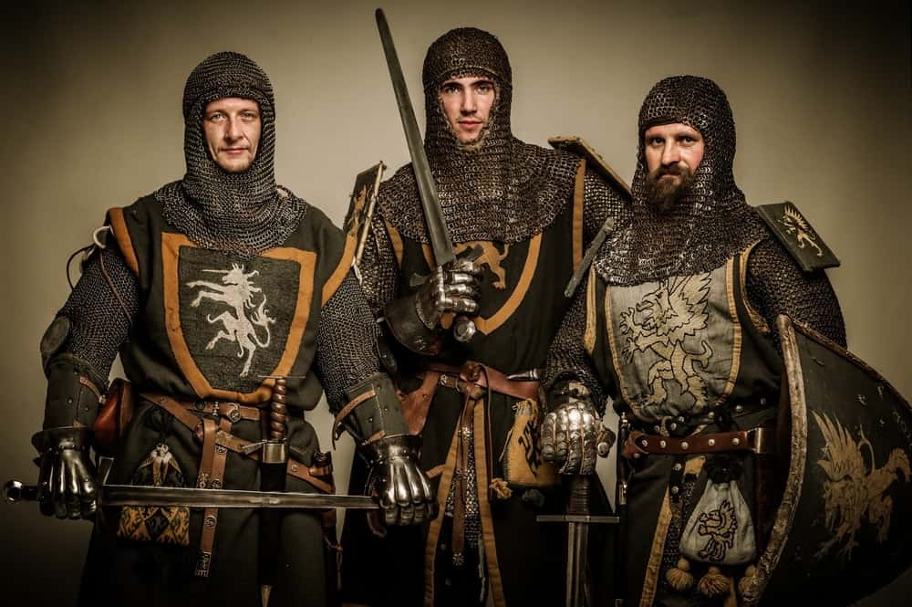 Three men in full medieval knight gear.