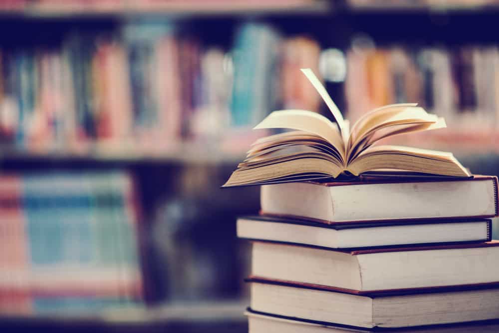 A close look at a stack of books in a library.