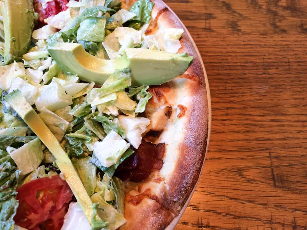 BLT pizza with mayonnaise and avocado.