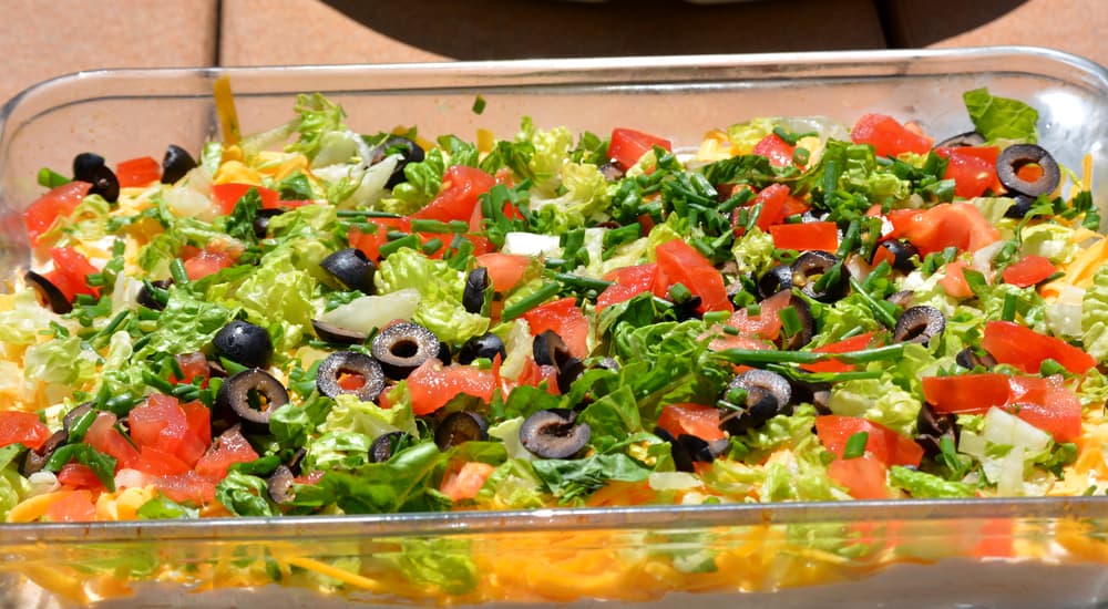 Taco dip in a glass container.