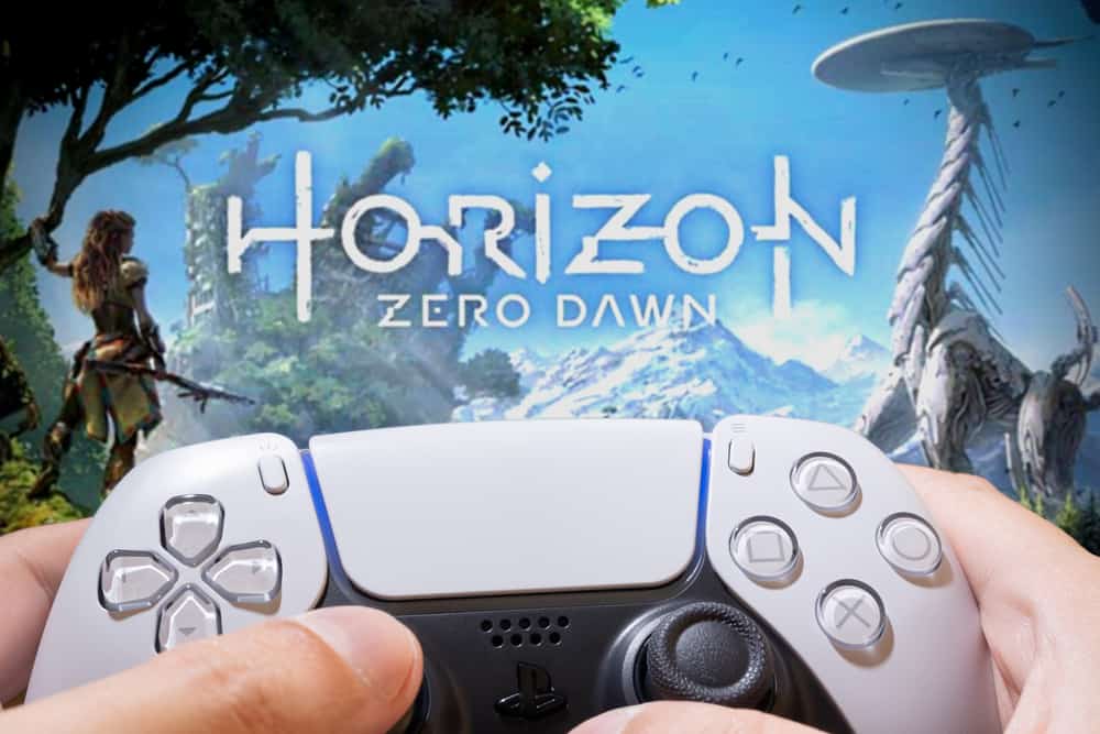 A man playing Horizon Zero Dawn with his console unit.