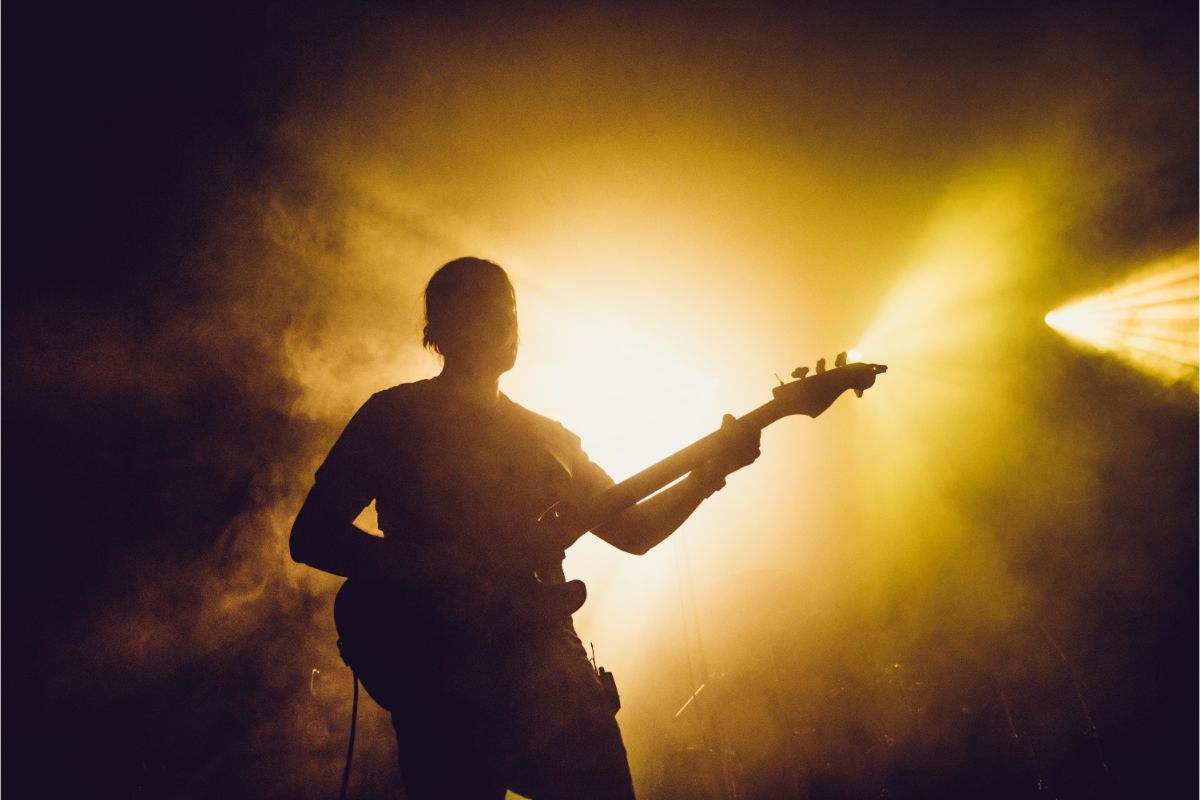 A guitarist silhouette on a stage.