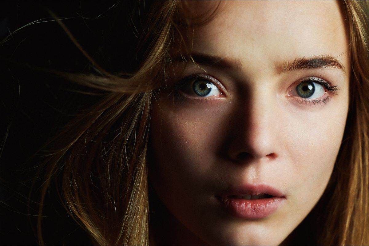 Close up photo of beautiful girl with piercing eyes looking to the camera.